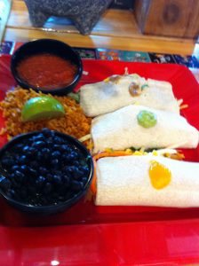 Amigo's Mexican food plate with meat, black beans and tacos