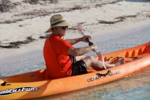 Man kayaking off the beach