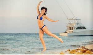 Fury girl jumps for a picture in the beach in Key West