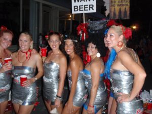 Women dressed as 7-pack conquering the Masquerade March in Key West