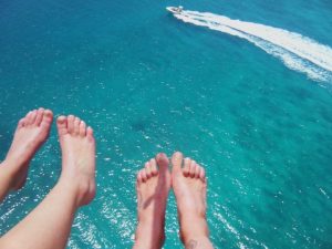 Winning photo of people's feet dangling of while parasailing with Fury In key West