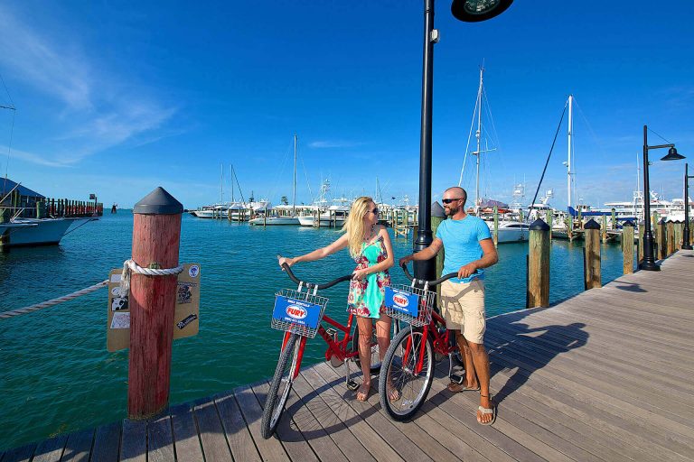 Couple riding rental bikes in the Historic Seaport in Key West