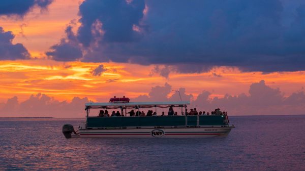 Fury Key West Corinthian Boat out on the ocean during sunset.