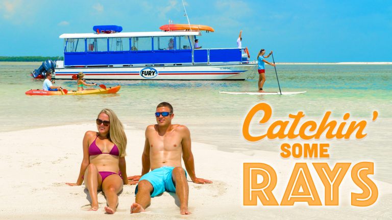 A couple sitting on Key West Beach enjoying a trip with Fury. With a title that reads Catchin' some rays