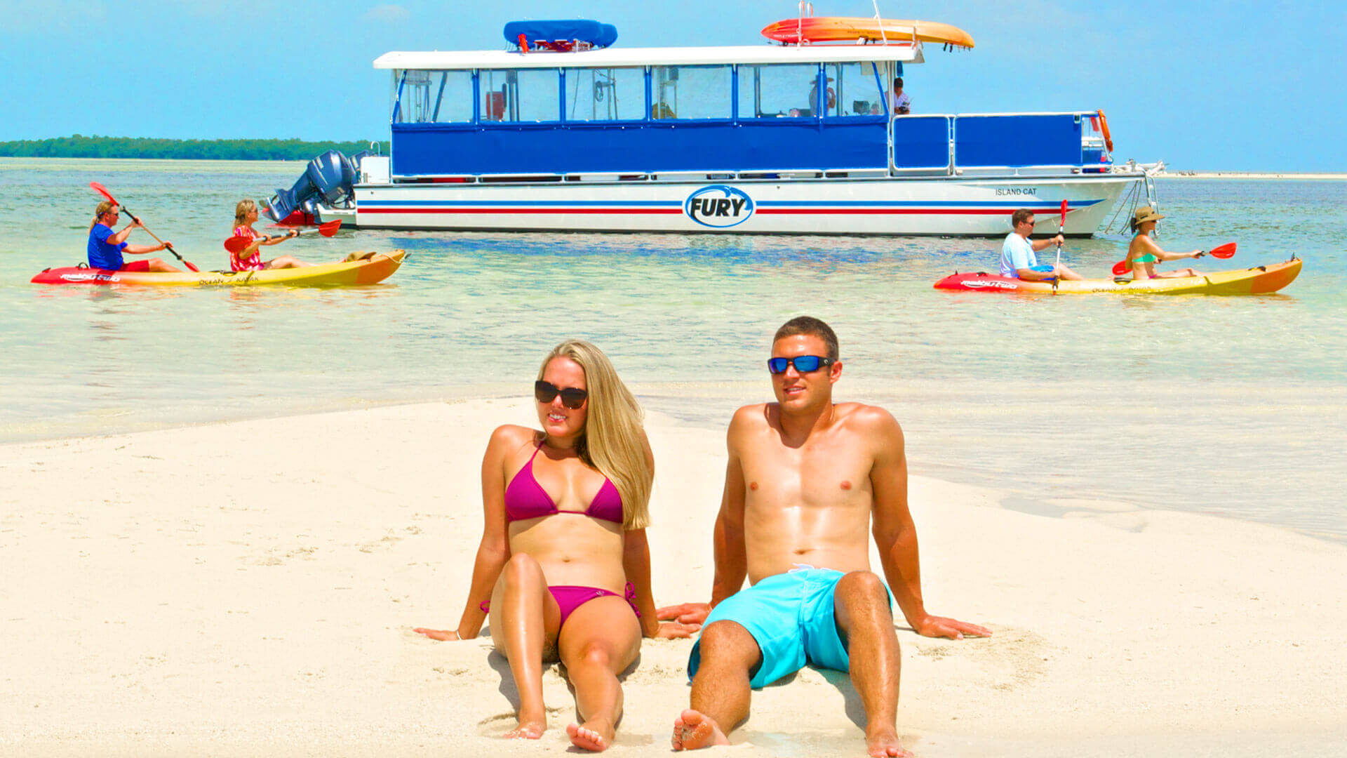 Image of couple relaxing on the sand during the Fury Island Adventure Tour