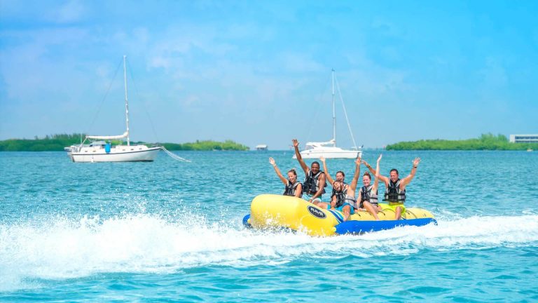 Friends riding a banana boat in the Ultimate Adventure trip