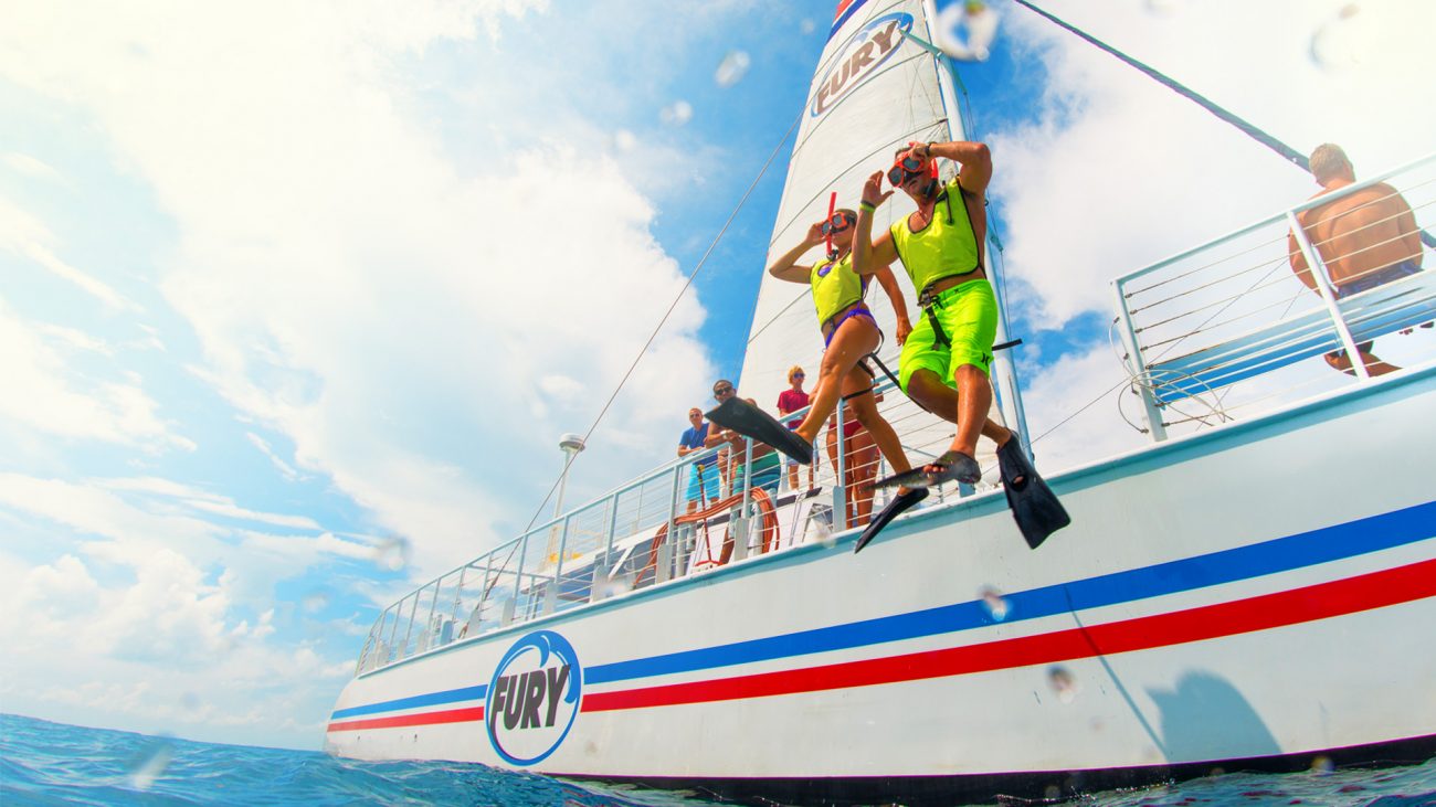 Snorkelers jumping off Fury boat