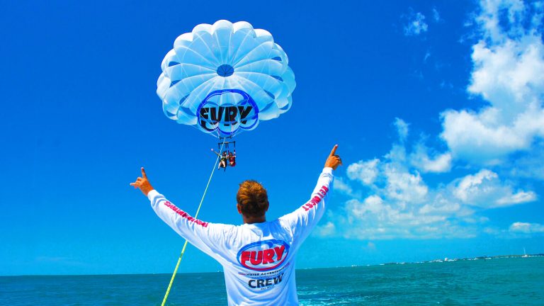 Man standing in front of people on a parasail