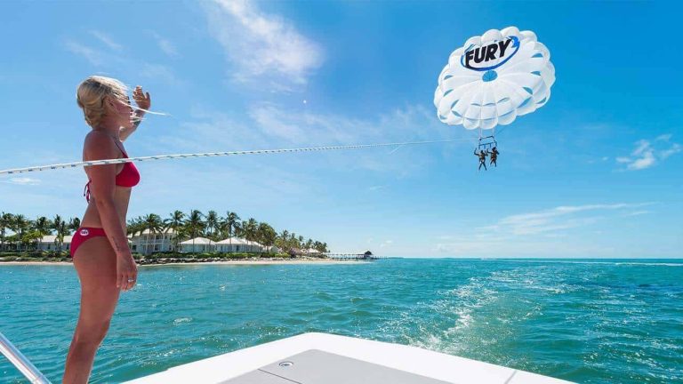 A Fury member waves at a couple parasailing in Key West