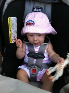 Baby Stella in her stroller in pink Fury merch
